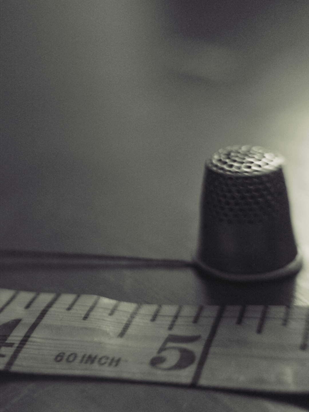vintage-thimble-and-measuring-tape-in-sepia-tones-zekj7mceaq0